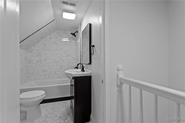 full bathroom with tiled shower / bath, vanity, and toilet