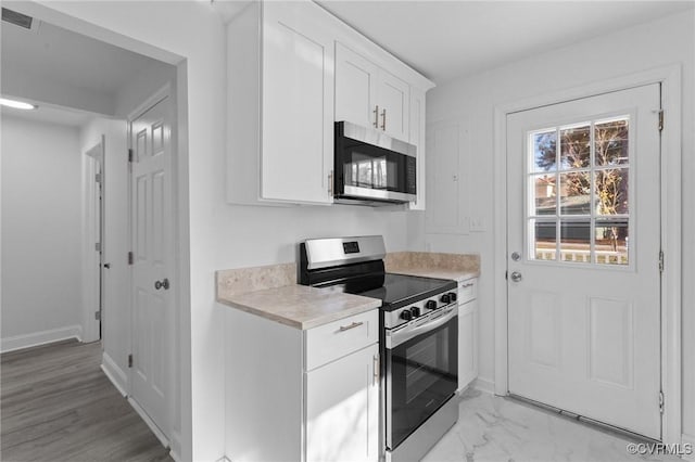 kitchen featuring white cabinets and appliances with stainless steel finishes