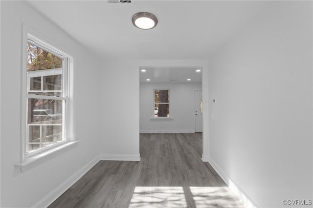 hallway with hardwood / wood-style floors