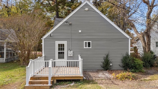 back of property featuring a wooden deck