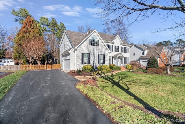 view of front of house with a garage and a front yard