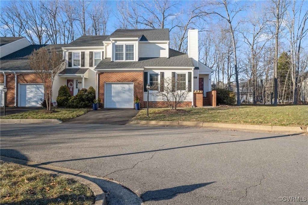 view of front of home with a garage and a front yard