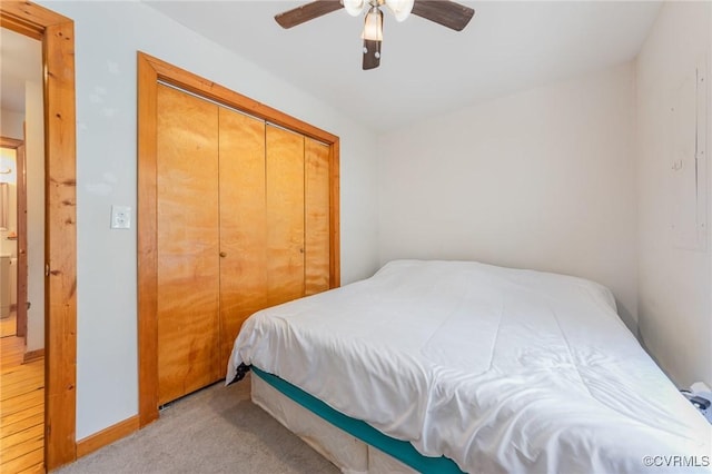 carpeted bedroom featuring a closet and ceiling fan