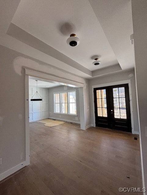9468 Angels Share Dr, New Kent, VA 23124 - foyer featuring french doors, baseboards, wood finished floors, and a tray ceiling