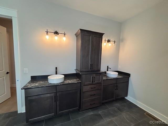 9468 Angels Share Dr, New Kent, VA 23124 - full bath with double vanity, a sink, visible vents, and baseboards