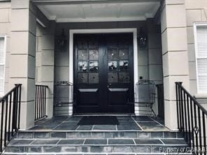 view of exterior entry featuring french doors