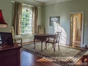 sitting room featuring hardwood / wood-style flooring and ornamental molding