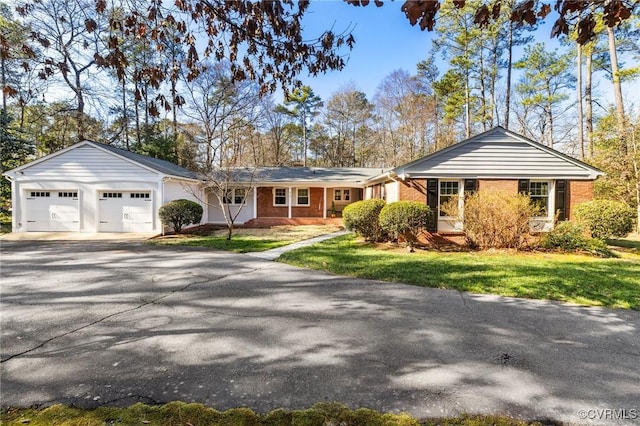 single story home with a garage and a front lawn