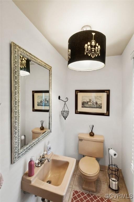 bathroom featuring toilet, tile patterned flooring, and sink