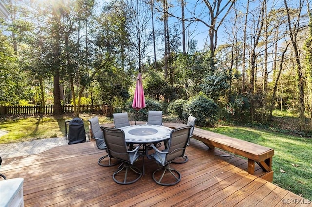 wooden terrace with a lawn