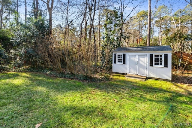 view of outbuilding with a lawn