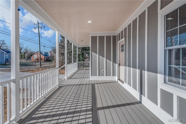 wooden terrace featuring covered porch