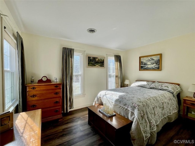 bedroom with dark hardwood / wood-style flooring