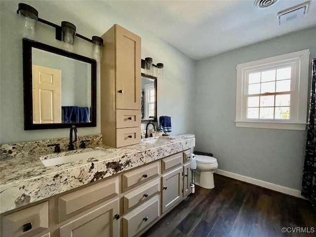 bathroom with hardwood / wood-style flooring, vanity, and toilet