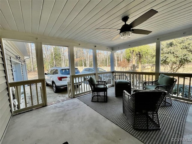 sunroom featuring ceiling fan and wooden ceiling