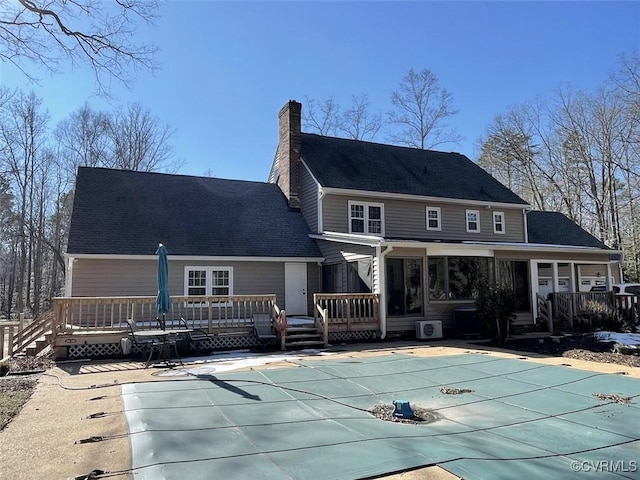 back of property featuring a swimming pool side deck