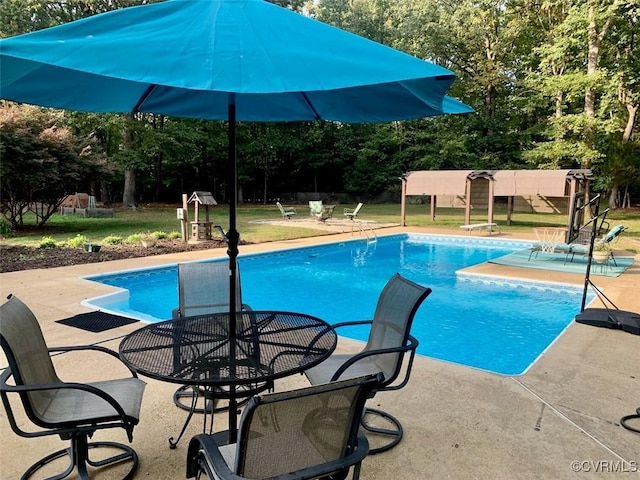 view of pool with a yard and a patio area