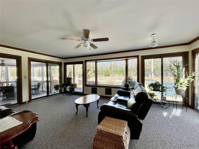 living room with crown molding, ceiling fan, and carpet flooring