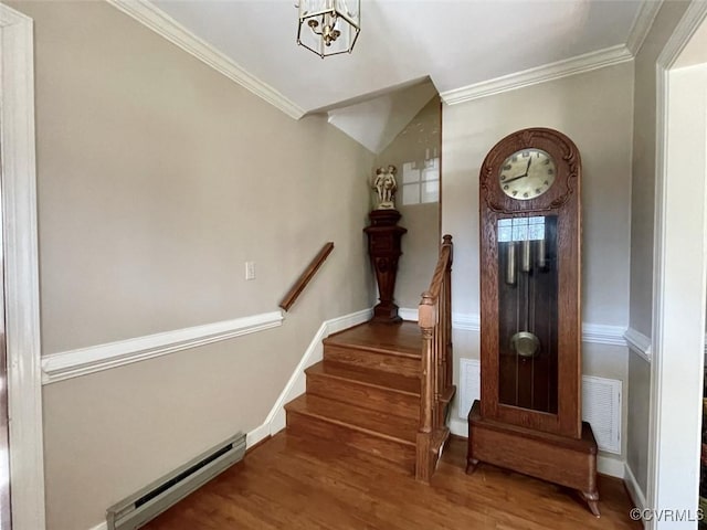 stairway featuring a notable chandelier, hardwood / wood-style flooring, a baseboard radiator, and ornamental molding