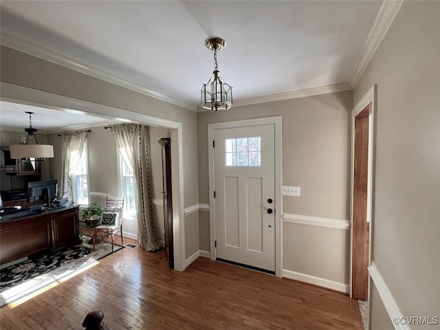 foyer with wood-type flooring and ornamental molding