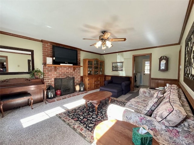 carpeted living room with washer / dryer, a fireplace, ornamental molding, and ceiling fan