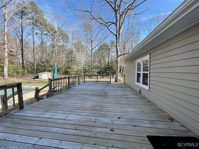 wooden terrace featuring a storage shed