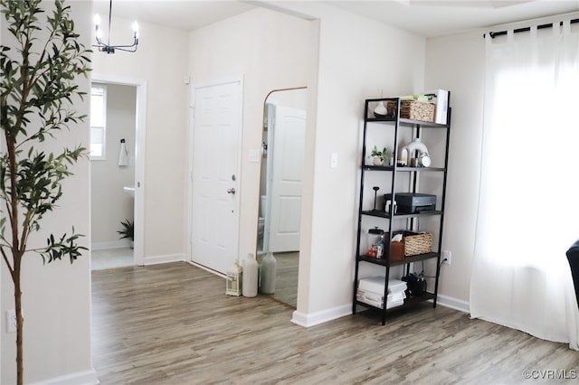 interior space with an inviting chandelier and wood-type flooring