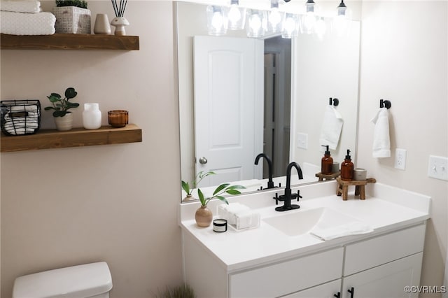 bathroom with vanity and toilet