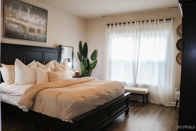 bedroom with dark hardwood / wood-style floors