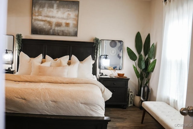 bedroom with dark hardwood / wood-style flooring