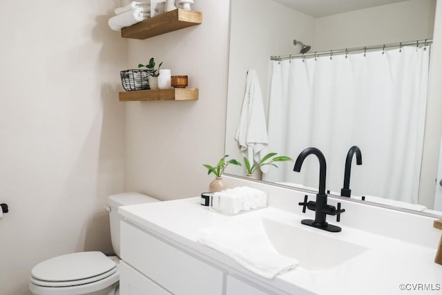 bathroom with vanity, curtained shower, and toilet