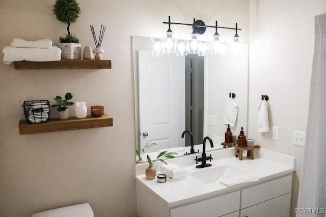 bathroom featuring vanity and toilet