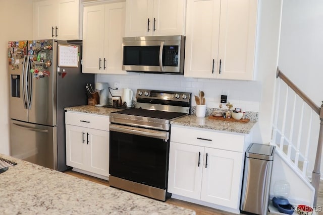 kitchen featuring white cabinetry, tasteful backsplash, and appliances with stainless steel finishes