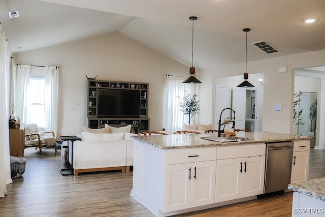 kitchen featuring pendant lighting, sink, lofted ceiling, dishwasher, and white cabinets