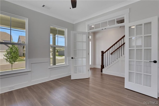 8900 Freebridge Rd, Chesterfield, VA 23832 - foyer with french doors, plenty of natural light, wood finished floors, a wainscoted wall, and ornamental molding