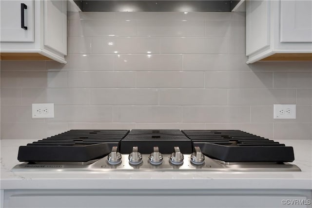 8900 Freebridge Rd, Chesterfield, VA 23832 - kitchen view of white cabinetry, backsplash, stainless steel gas stovetop, and extractor fan