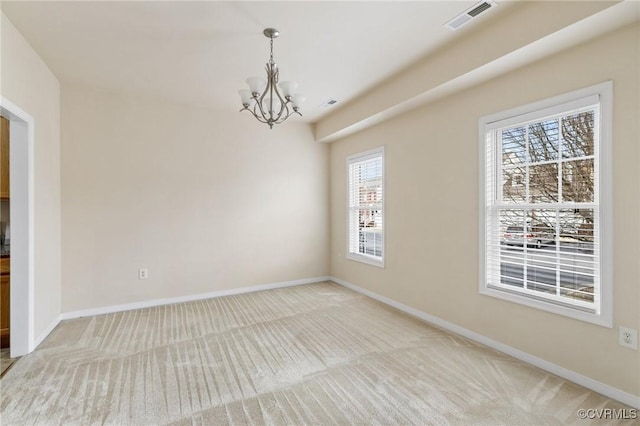 unfurnished room with light carpet and a notable chandelier