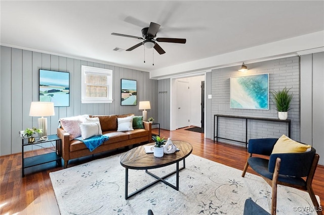 living room featuring wood-type flooring and ceiling fan