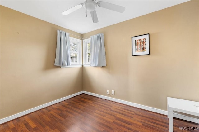 empty room featuring ceiling fan and dark hardwood / wood-style flooring