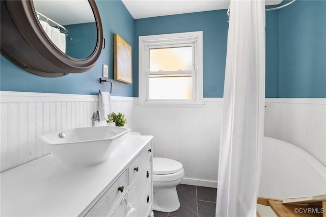 bathroom featuring vanity, toilet, and tile patterned flooring