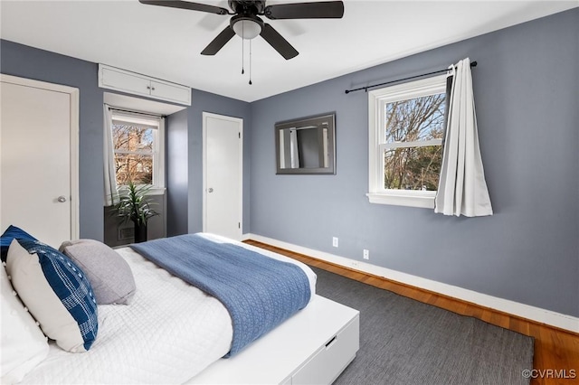 bedroom featuring ceiling fan and dark hardwood / wood-style flooring