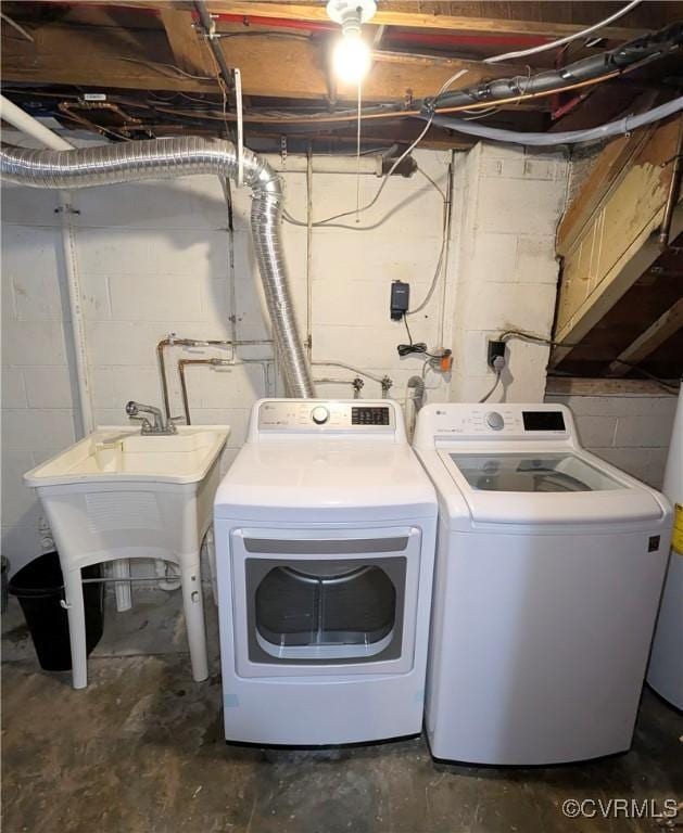 washroom with cabinets, washing machine and clothes dryer, and sink