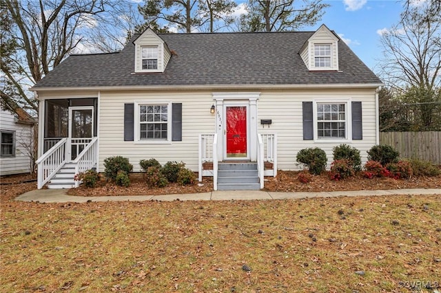 cape cod-style house featuring a front lawn