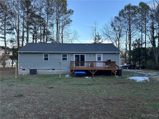 back of house featuring a wooden deck, central AC unit, and a lawn