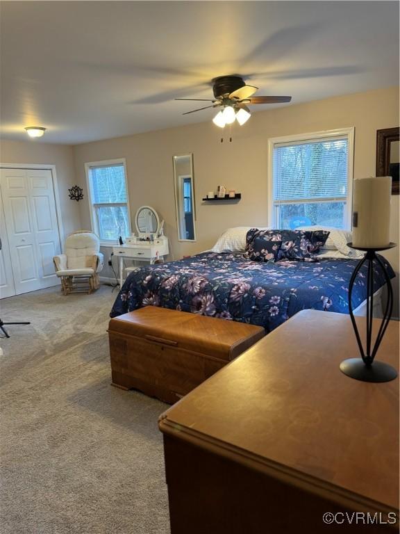 bedroom with a closet, ceiling fan, and carpet