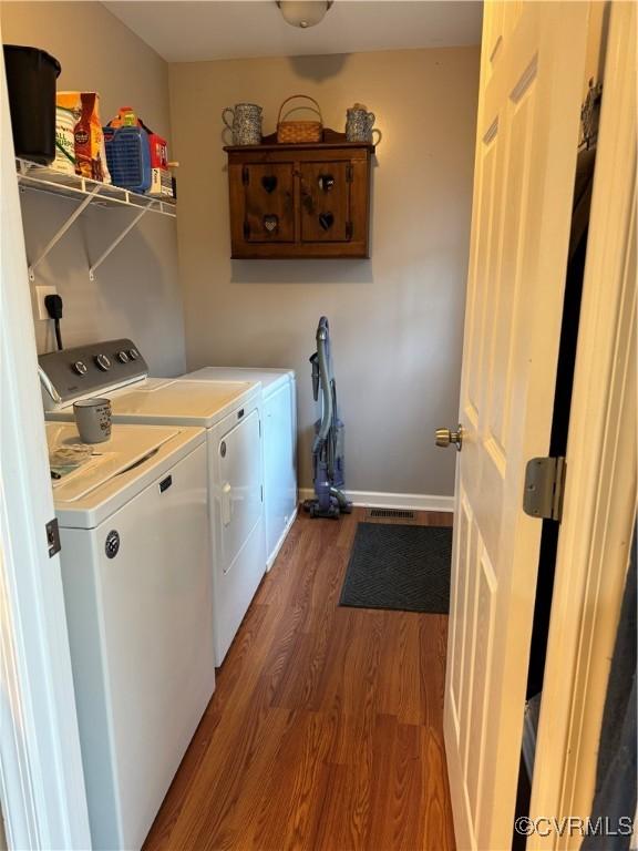 washroom with washer and dryer and hardwood / wood-style floors