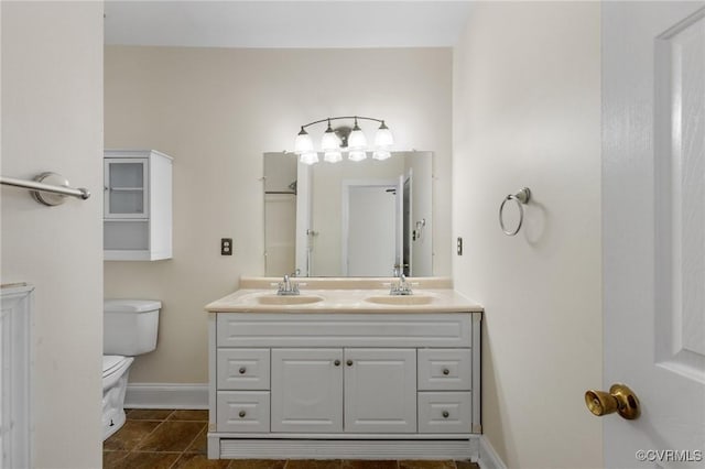 bathroom with vanity, tile patterned floors, and toilet