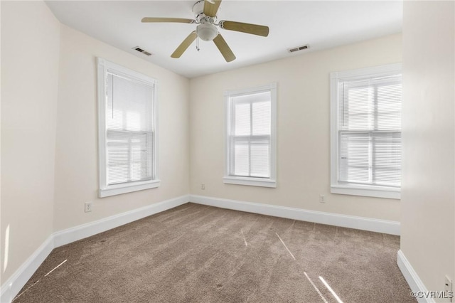 carpeted spare room with ceiling fan