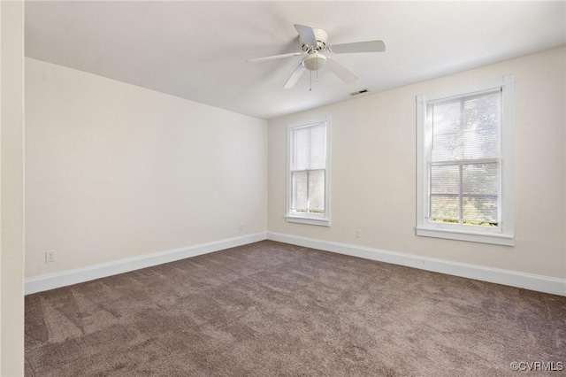 carpeted spare room with ceiling fan