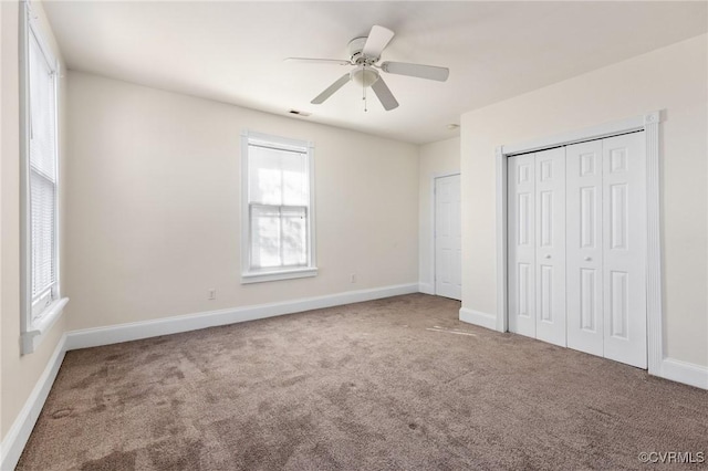 unfurnished bedroom with ceiling fan and carpet flooring